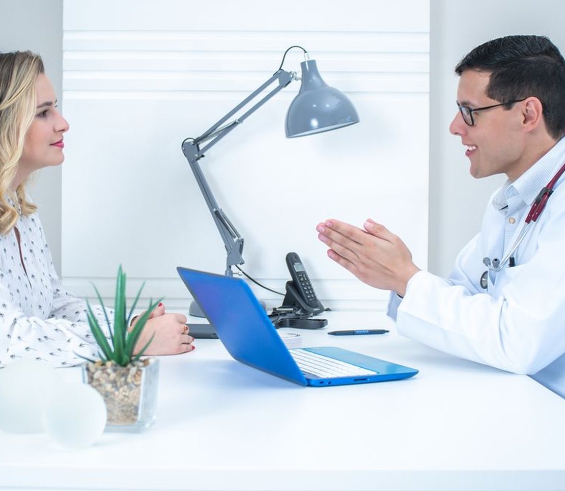 A Pulse Core Health clinician welcoming a patient in a bright modern clinic